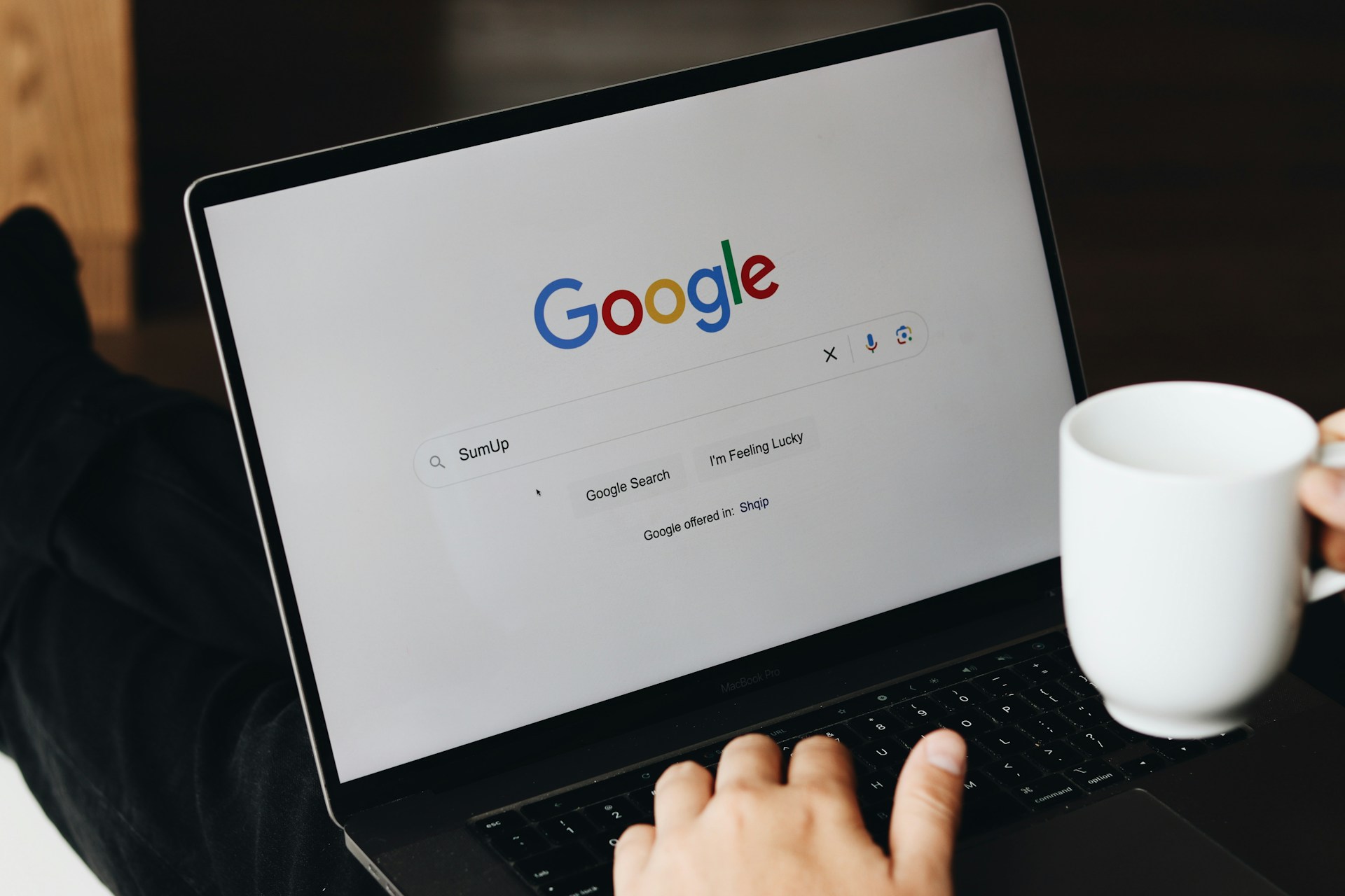 A studio owner setting up their Google Business Profile on a laptop at the front desk